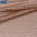 Tissu en maille à paillettes or rose